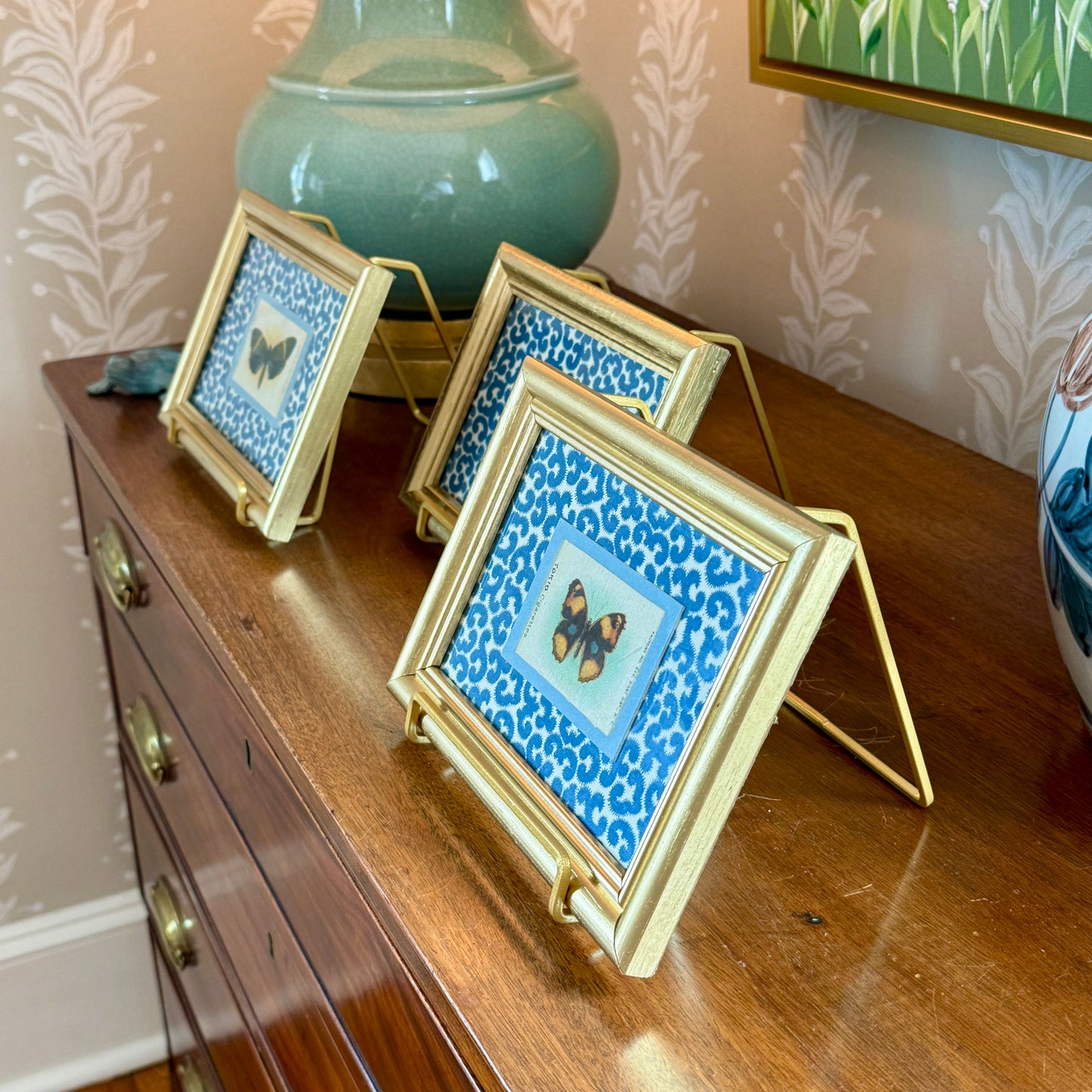 Set of Three Antique Butterfly Tobacco Silks on Blue and White Fabric in Gold Frames