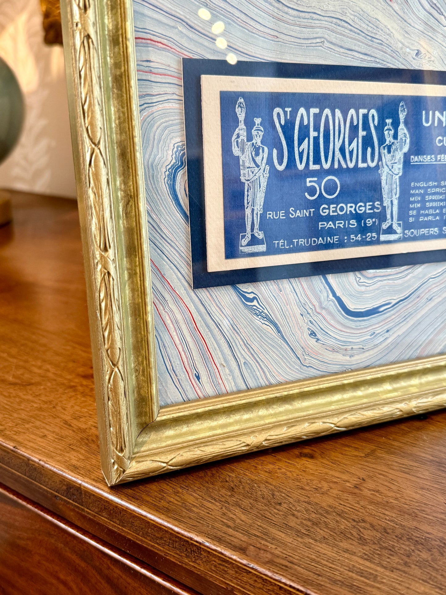 Antique Saint Georges Unique Curiosities Paris France Advertisement Card on Blue Marbled Mount in Gold Frame