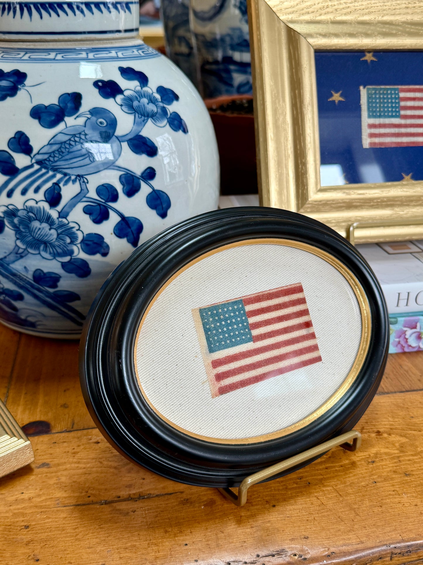Antique 48 Star Parade Flag on Ivory Twill in Gilded Thick Black Oval Frame