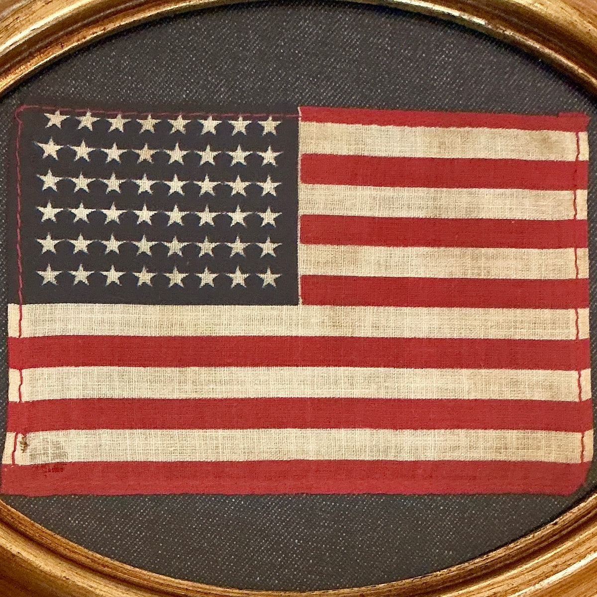 Vintage 48 Star American Flag on Dark Chambray in Oval Gold Frame