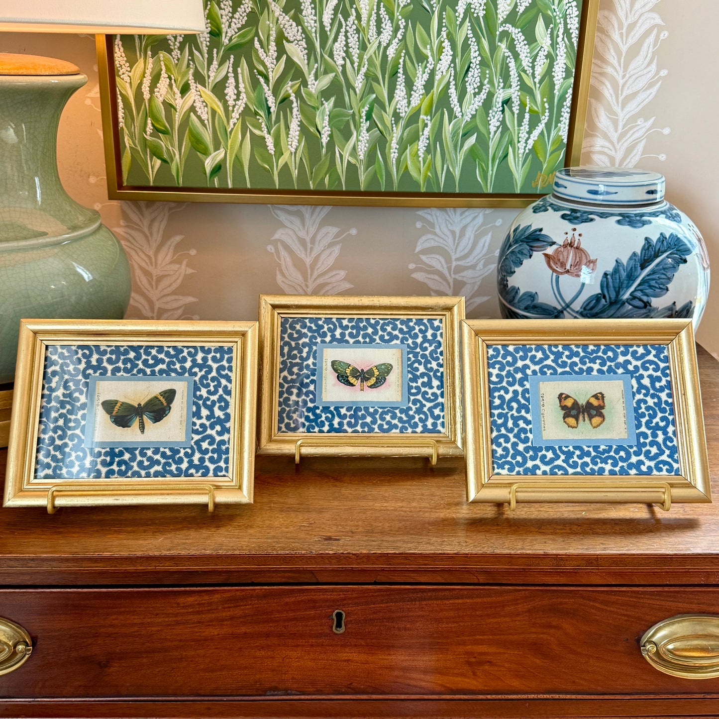 Set of Three Antique Butterfly Tobacco Silks on Blue and White Fabric in Gold Frames