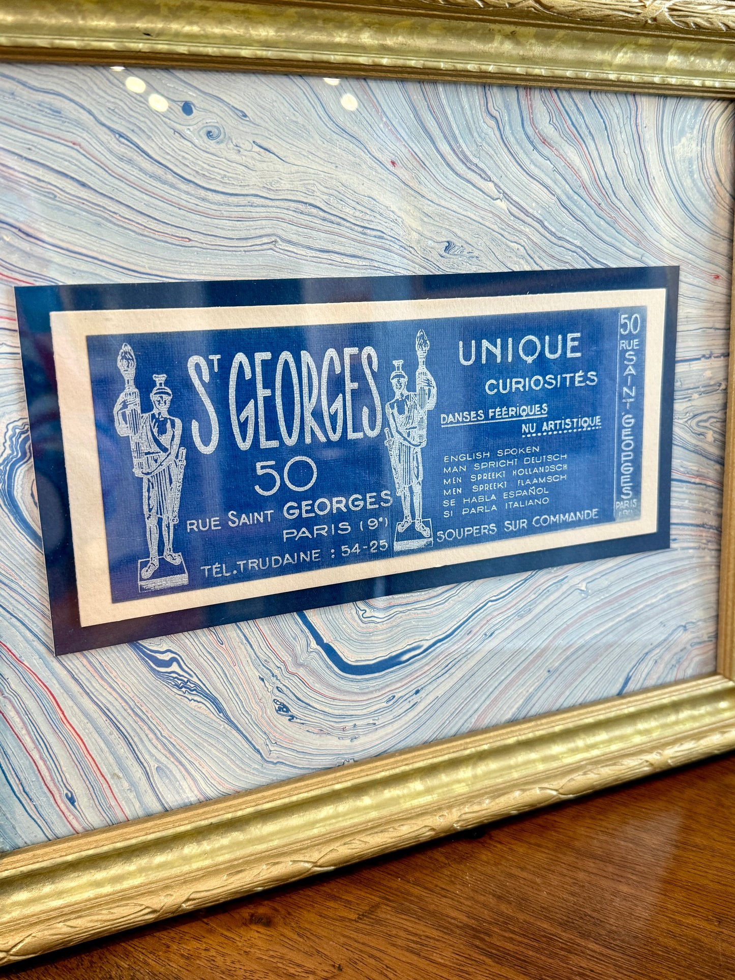 Antique Saint Georges Unique Curiosities Paris France Advertisement Card on Blue Marbled Mount in Gold Frame