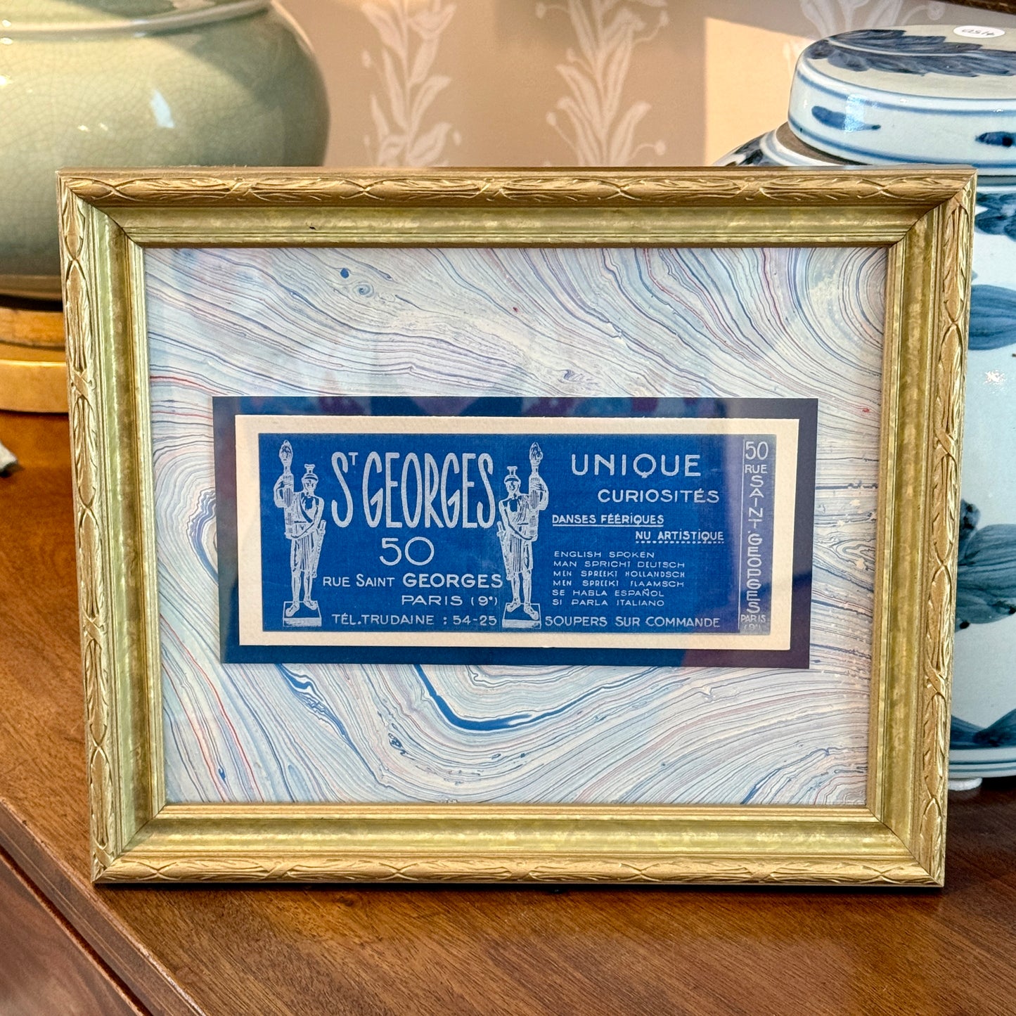 Antique Saint Georges Unique Curiosities Paris France Advertisement Card on Blue Marbled Mount in Gold Frame
