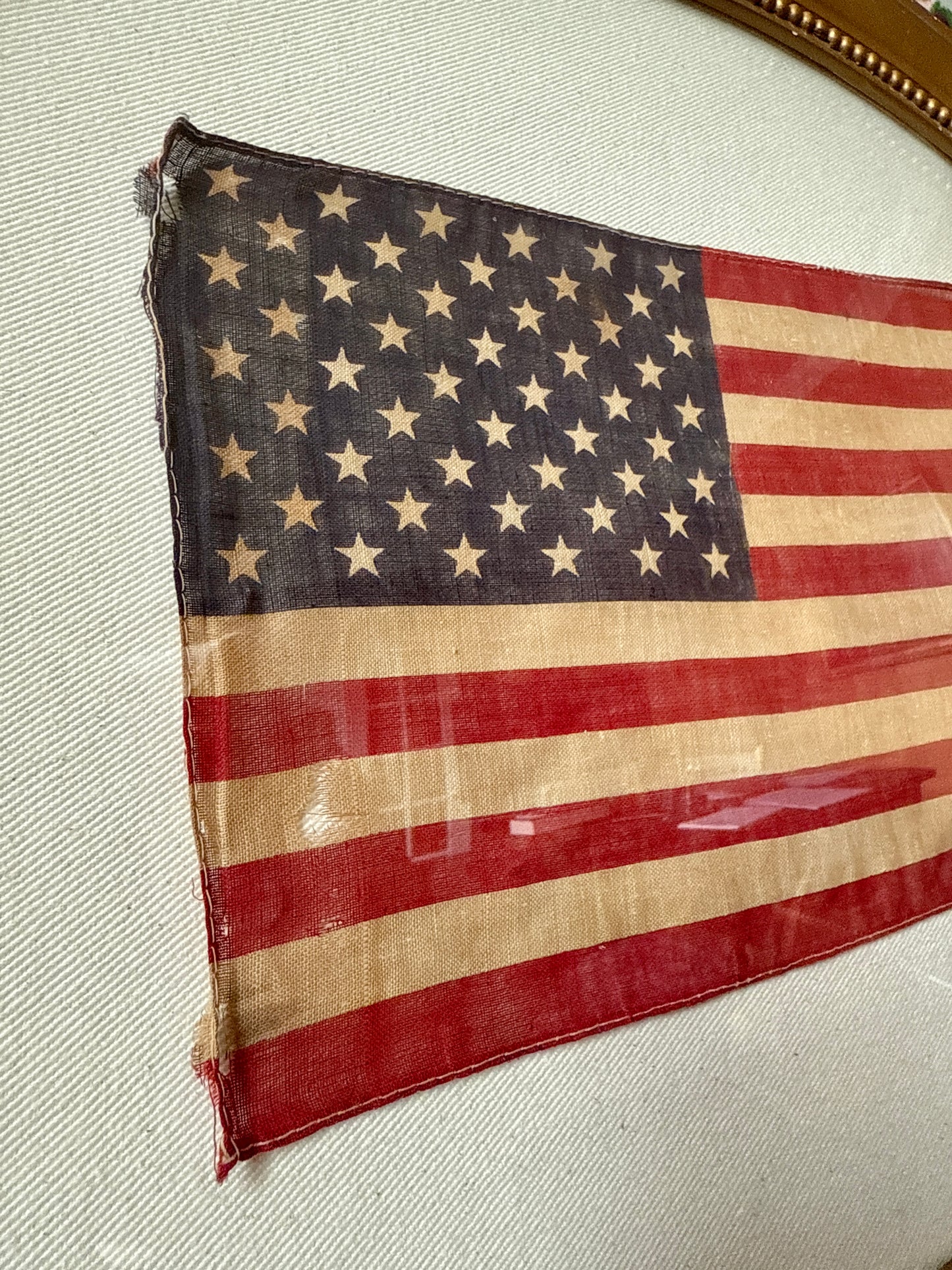 Old 50 Star American Parade Flag on Duck Cloth under Convex Glass in Antique Oval Gold Frame