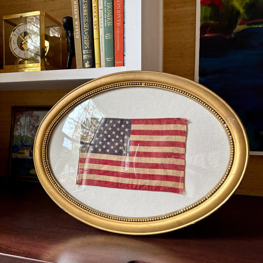 Old 50 Star American Parade Flag on Duck Cloth under Convex Glass in Antique Oval Gold Frame