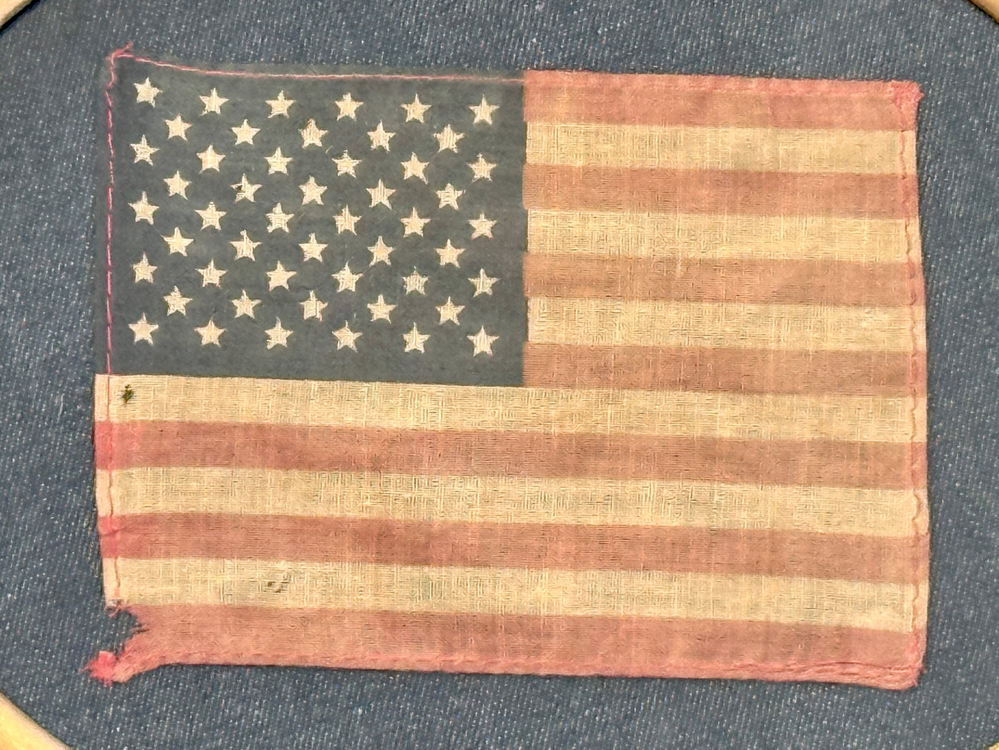 Vintage 50 Star American Parade Flag on Dark Chambray in Walnut Oval Wood Frame