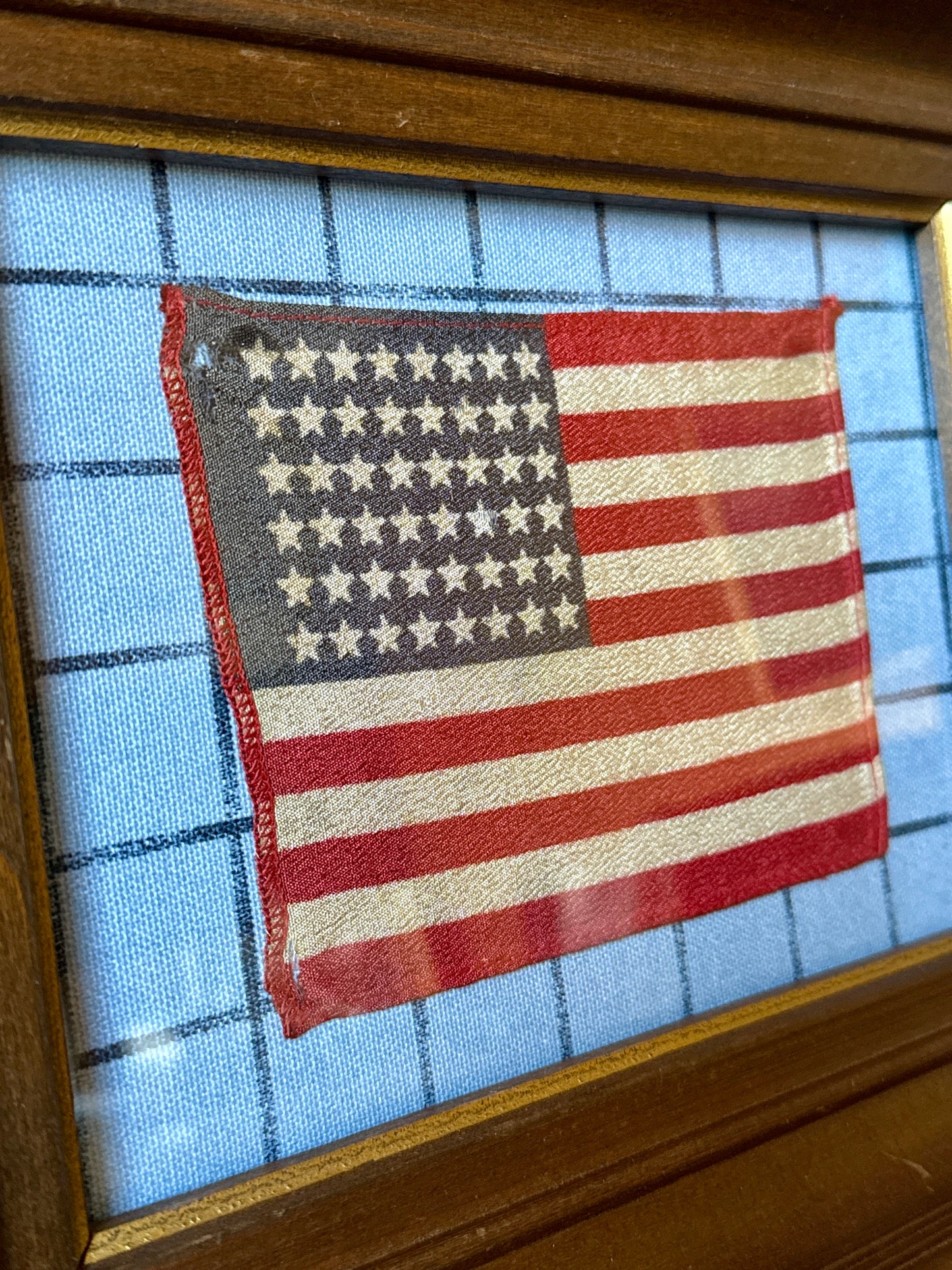 Old 48 Star American Parade Flag on Blue Windowpane Fabric in Deep Wood Frame