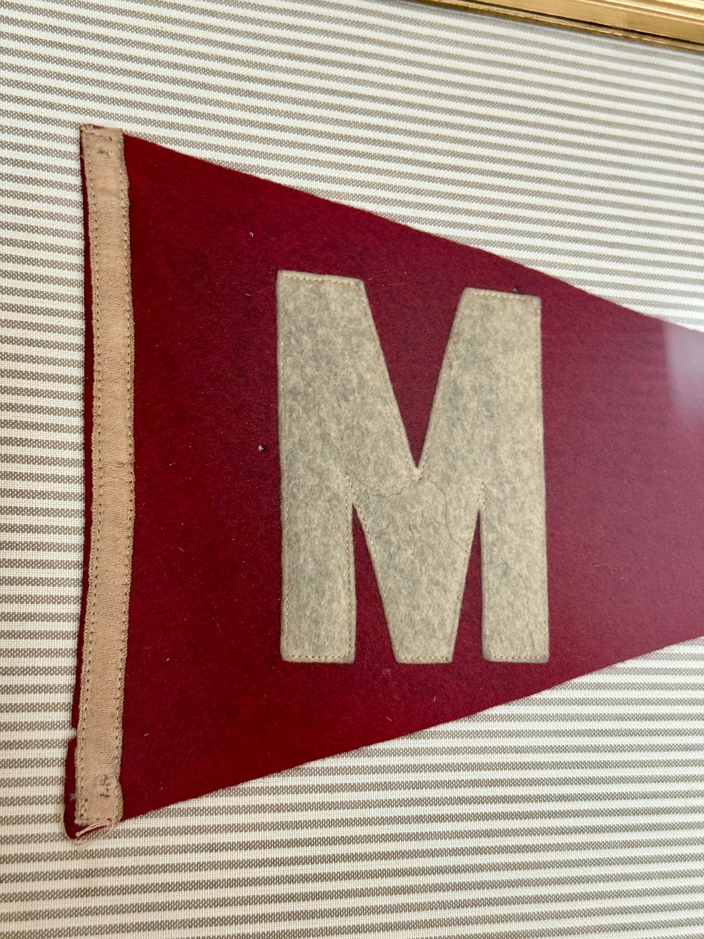 Antique Wool Felt Initial Pennant Flag "M" on Taupe Ticking Stripes in Vintage Gold Frame